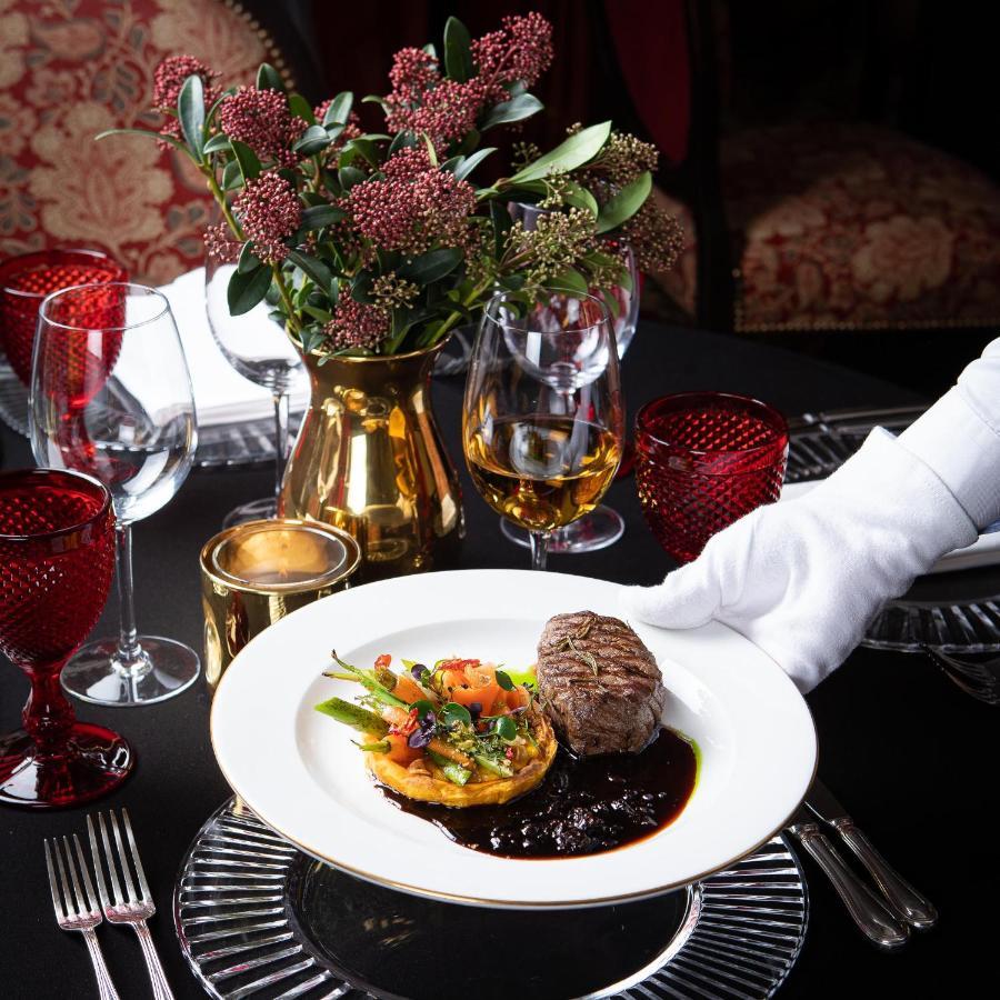 Narutis Hotel - Small Luxury Hotels Of The World Vilnius Exterior photo A waiter serving a meal